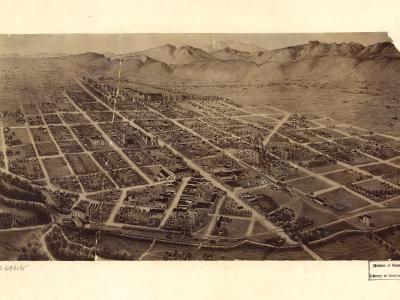 A sepia-toned historical bird's-eye view map or lithograph depicting a grid-planned town with scattered buildings, open fields, and mountains in the background, featuring Library of Congress stamping and handwritten numbers.