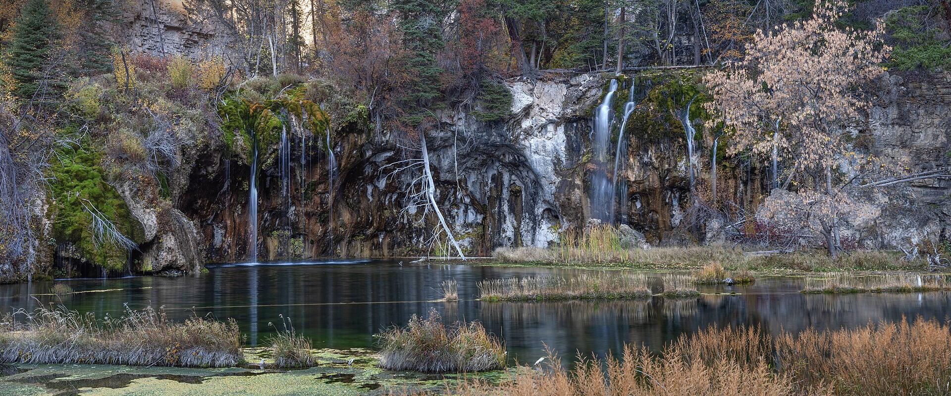 Waterfalls spilling into the turquoise travertine pool of Hanging Lake