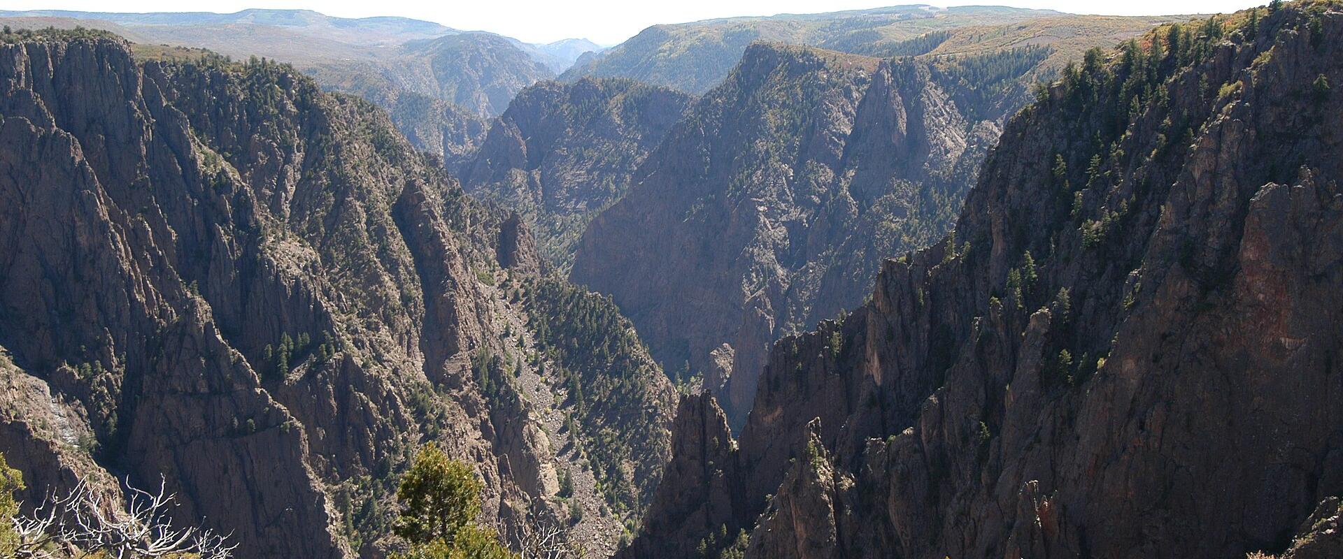 Sheer dark walls of the Black Canyon of the Gunnison seen from Tomichi Point on the South Rim