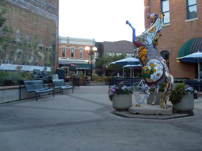 Old Town Fort Collins historic district plaza with a painted horse sculpture and brick storefronts