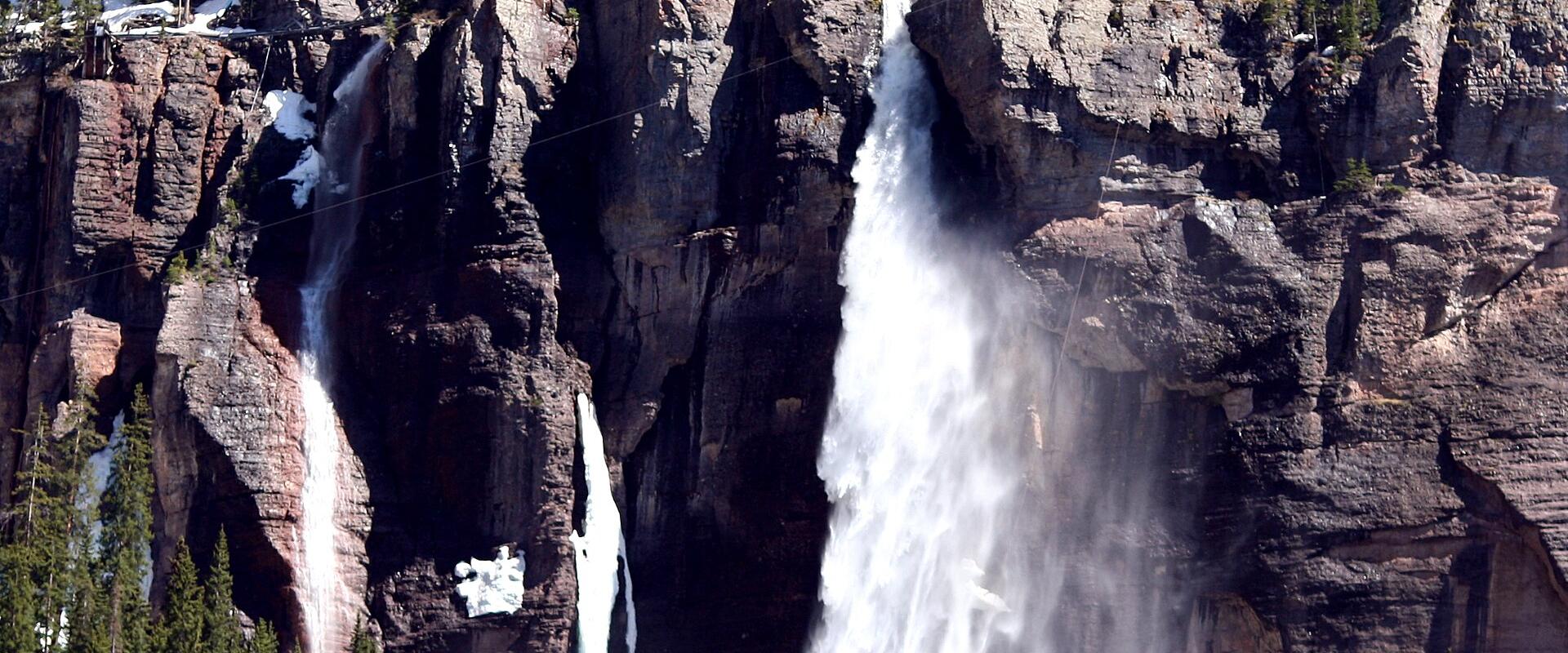 Bridal Veil Falls plunging from the cliff below its historic power plant, Telluride